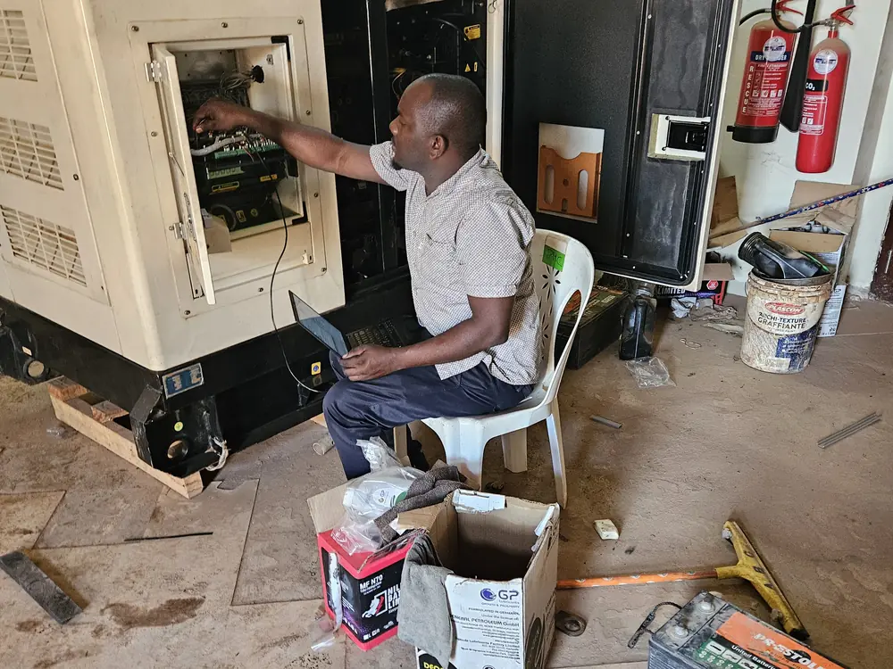 Technician carrying out maintenance on a generator